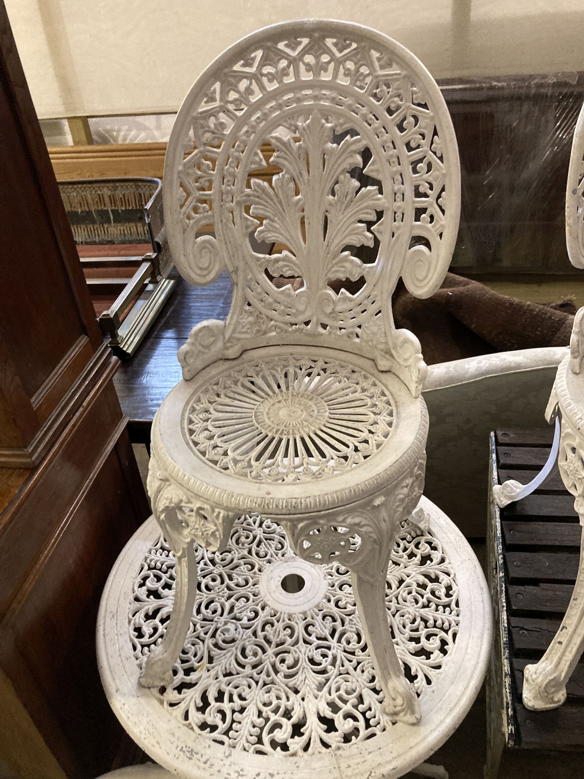 A Victorian style painted aluminium circular garden table, 69cm diameter together with a set of four similar chairs